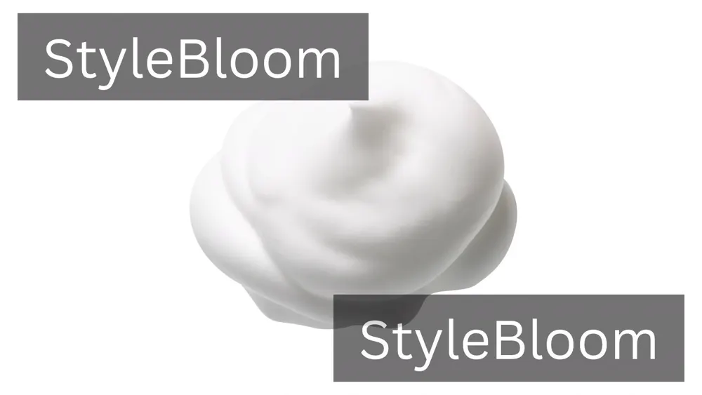 A dollop of white mousse foam on a pale background
