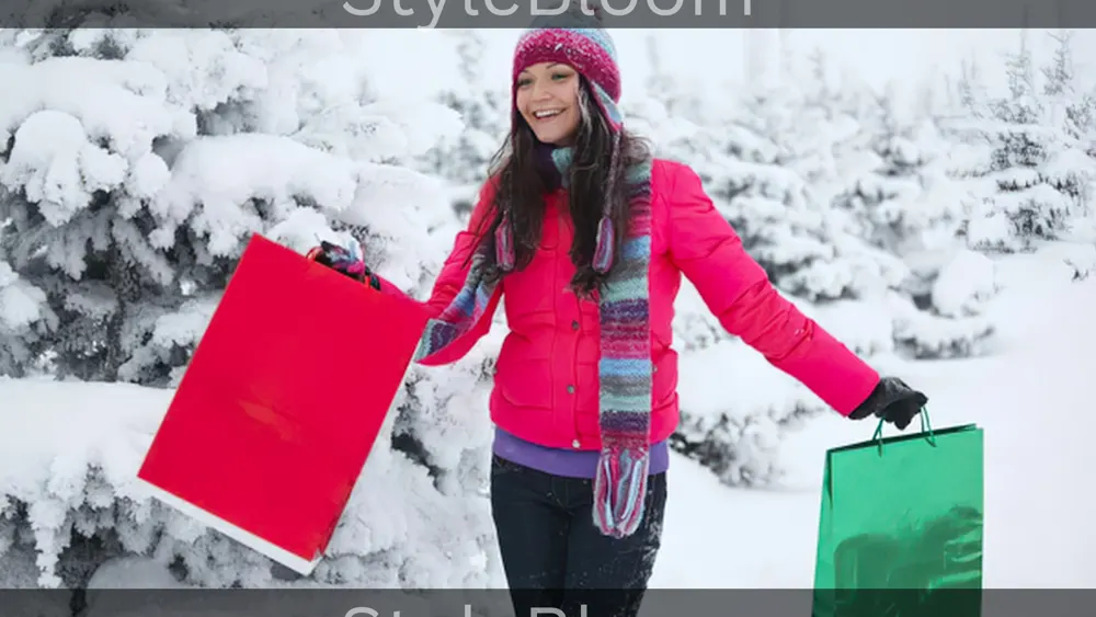 A woman in a pink winter coat holding blank red and green shopping bags in the snow, with snow-covered trees behind her.