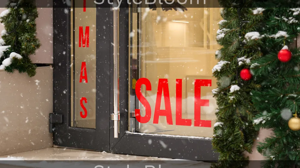 A shop entrance with a red SALE sign in the window, snow-dusted greenery and baubles beside the door.