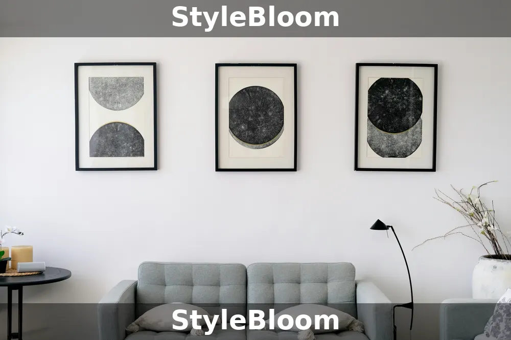 Three matching black frames with black-and-white abstract prints above a gray sofa