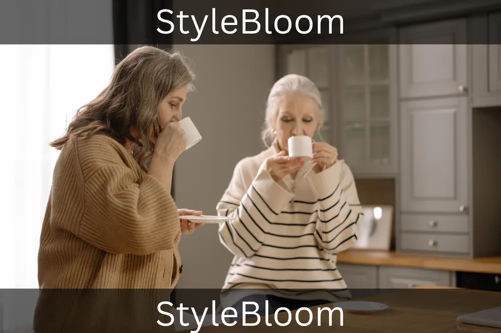 Two women sharing a warm drink in a bright kitchen