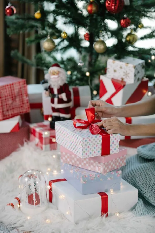 Wrapped Christmas gifts for Mum waiting under the tree on Christmas morning