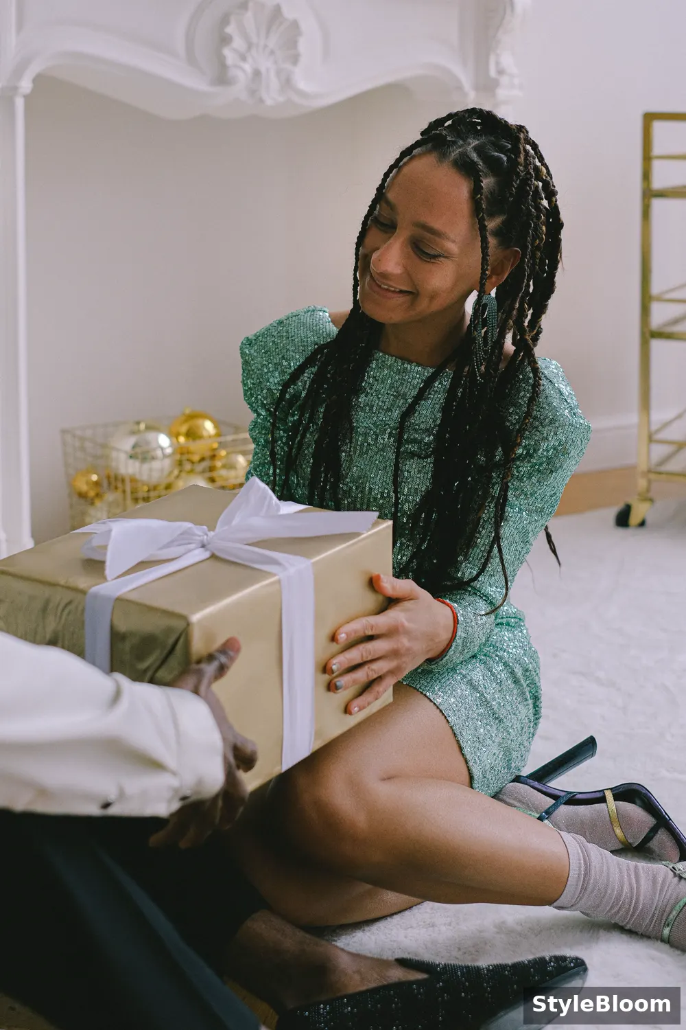 A smiling woman receiving a wrapped gift box