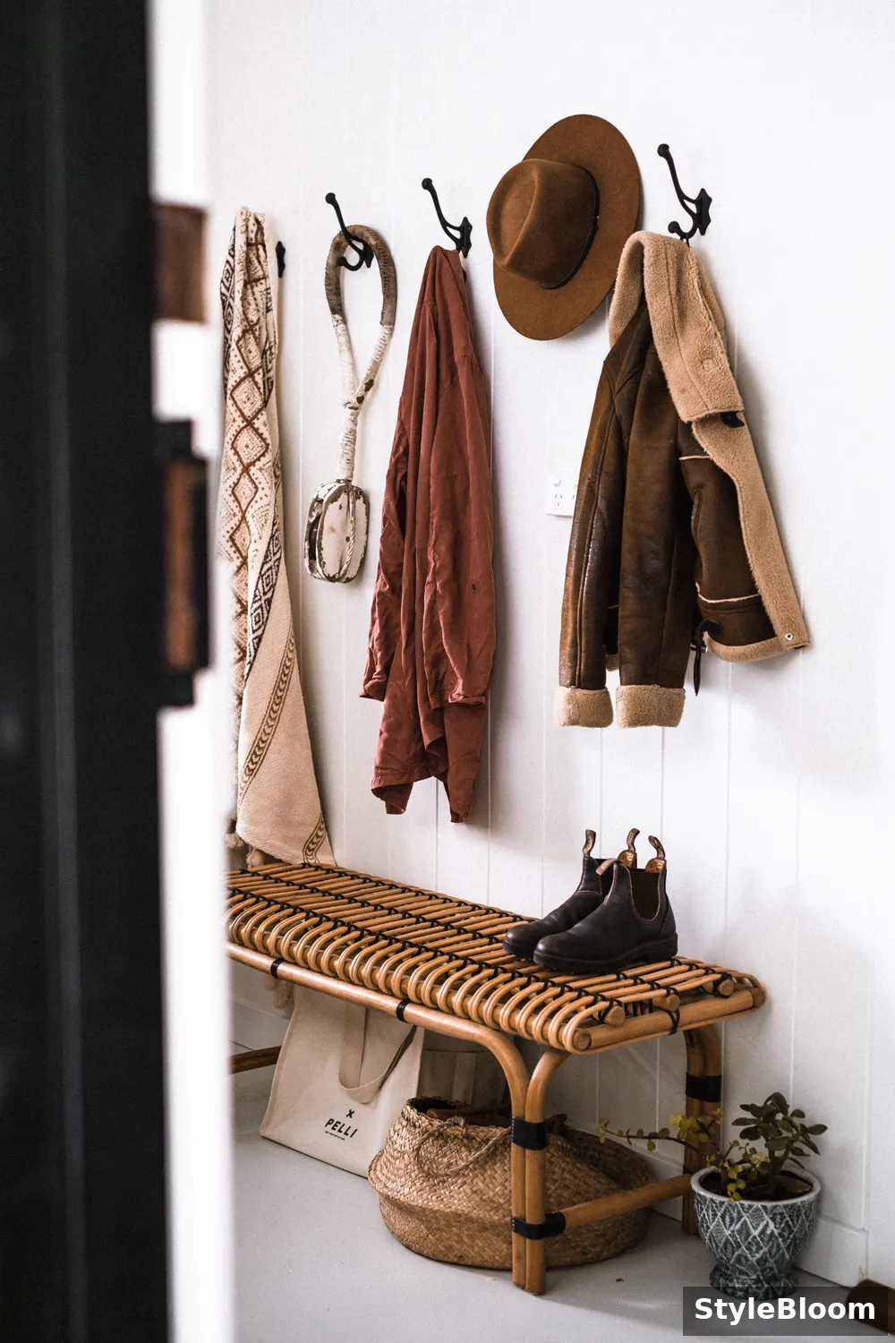 An entryway drop zone with hooks, baskets, and shoe storage