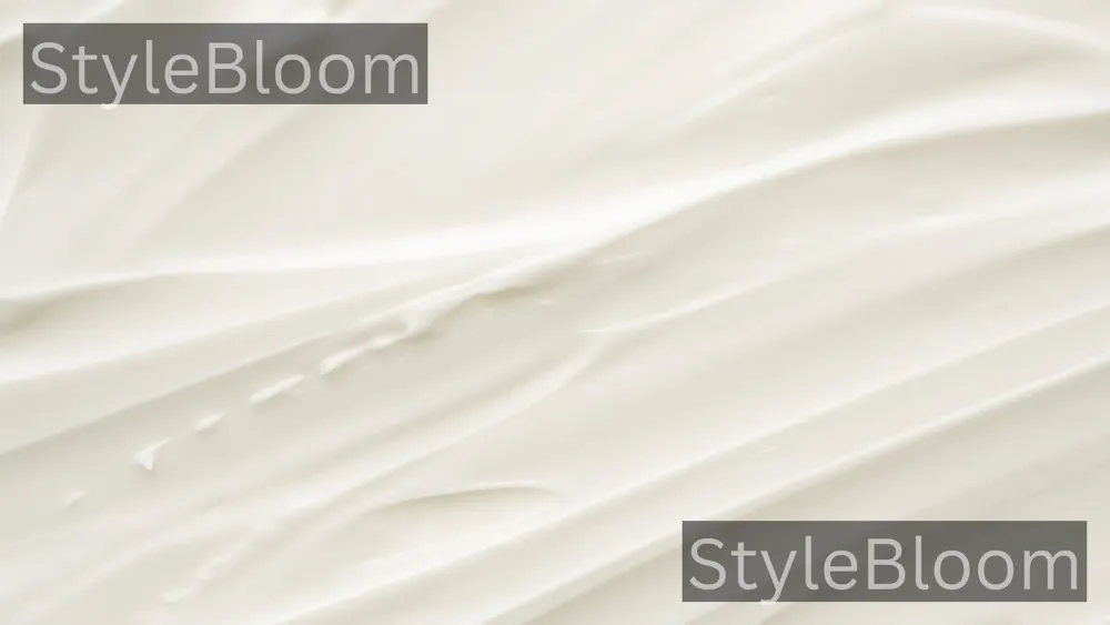 A light lotion swatch on a neutral background