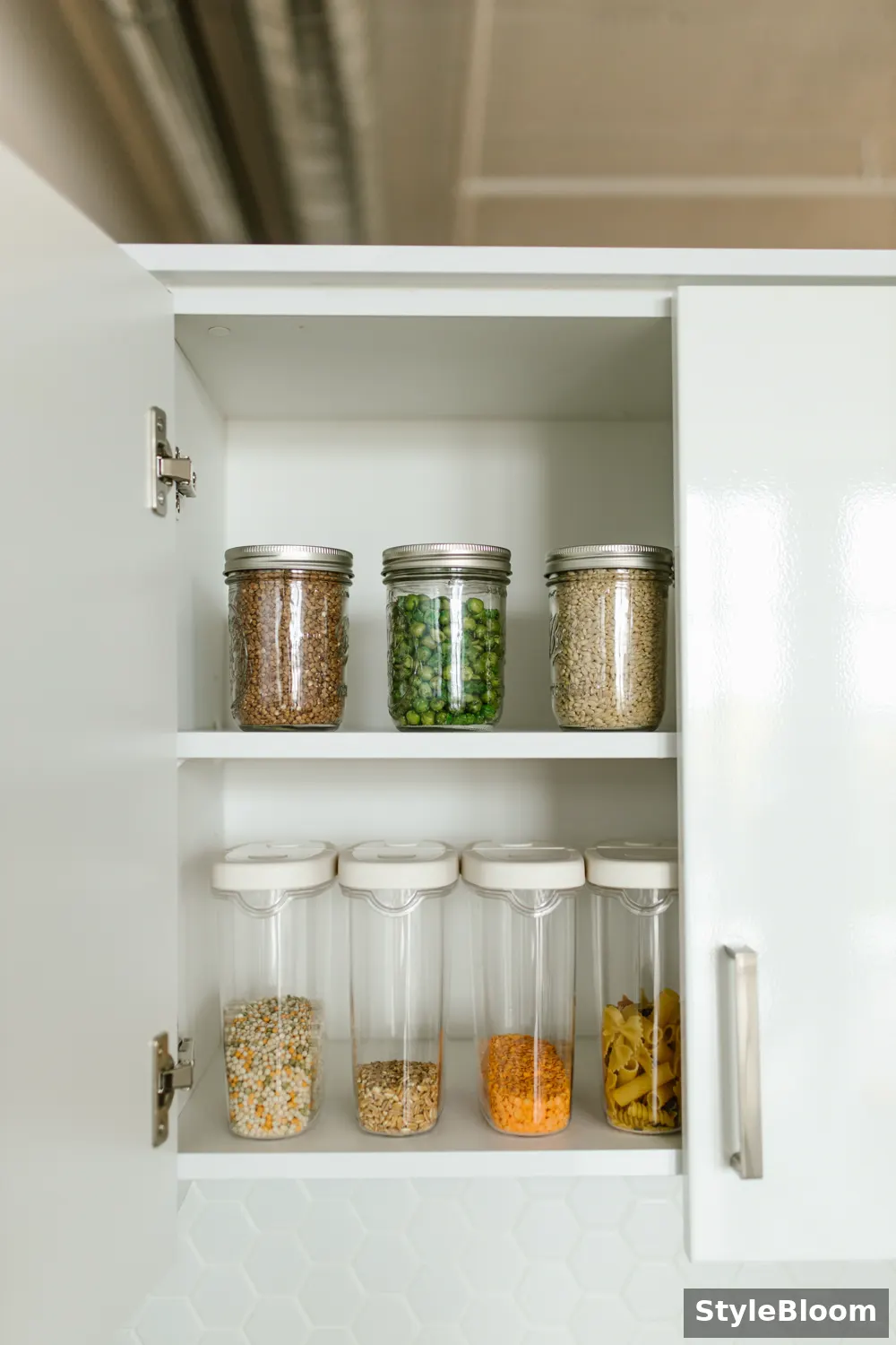A tidy pantry cabinet with its door open, jars and containers arranged on two shelves