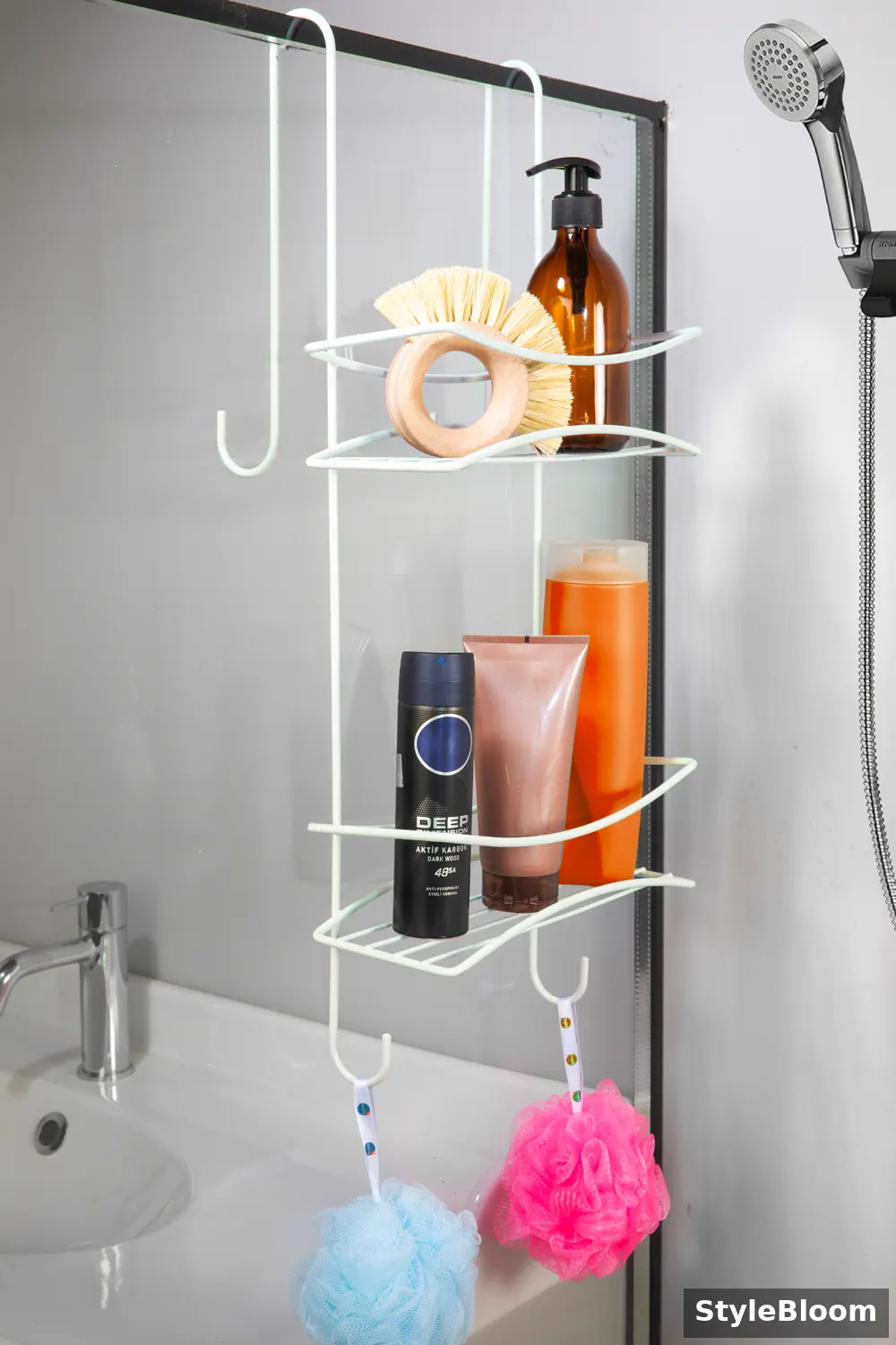 White wire caddy hooked over a glass shower door