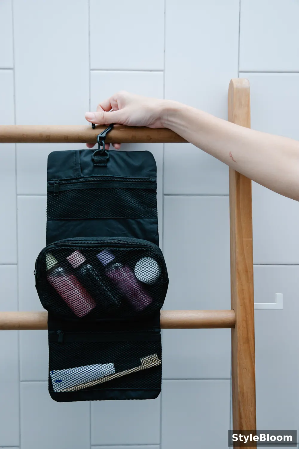 Black hanging pouch with mesh pockets holding bottles