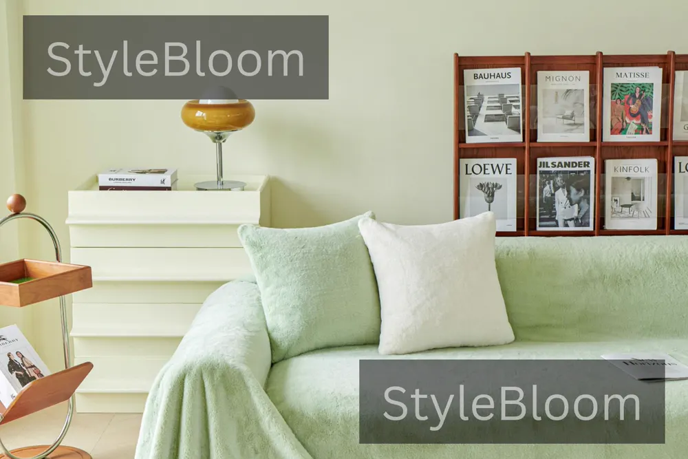 A sofa with a light green cover and mint and white cushions in a living room