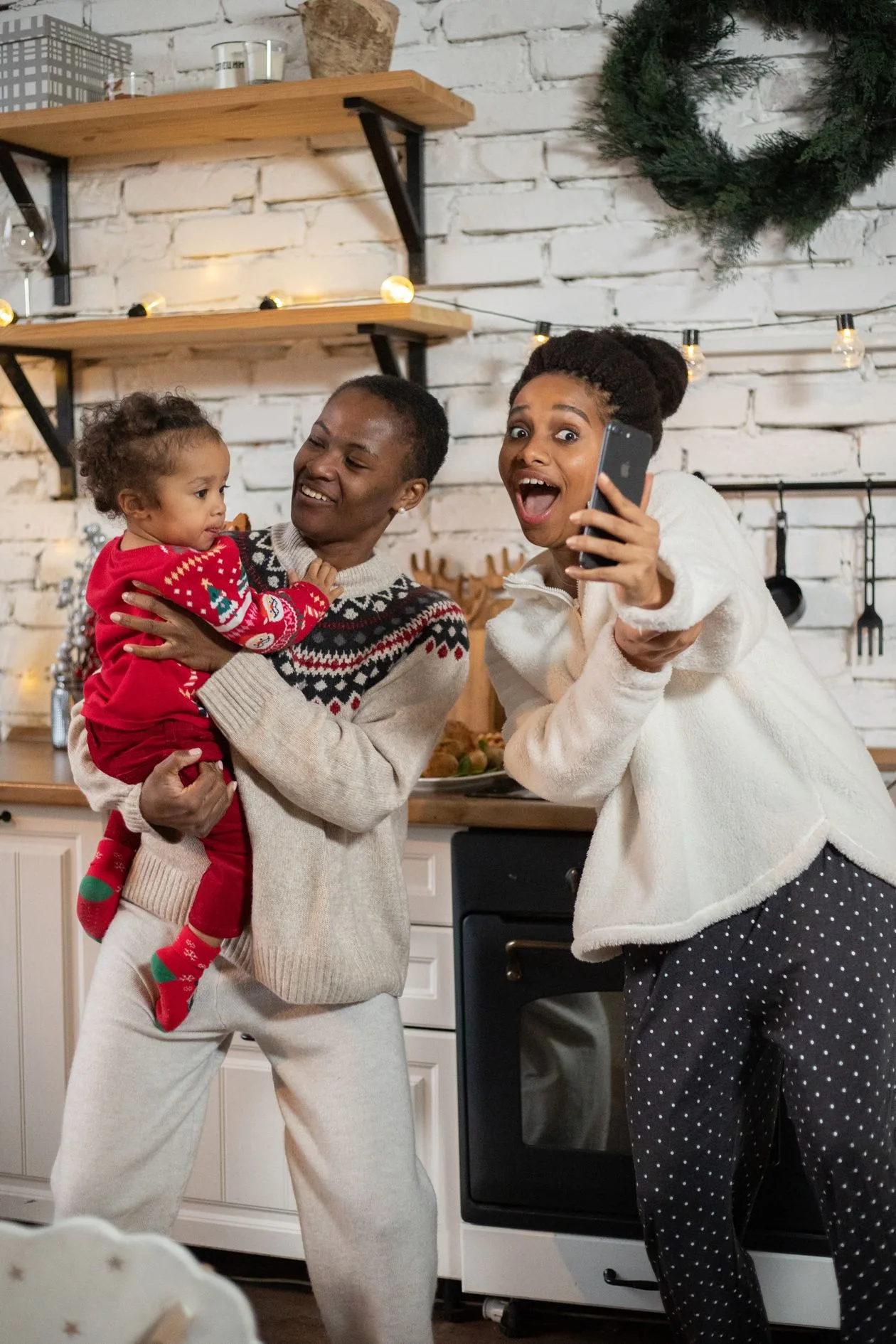 A family on a festive video call in the kitchen — staying close to a nan who lives far away at Christmas
